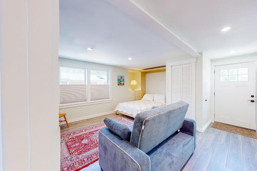 a living room with a chair and a bed at Shorelands 44-2 in Kennebunk
