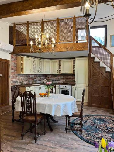 a large kitchen with a table and a staircase at River's house, free parking! in Sofia
