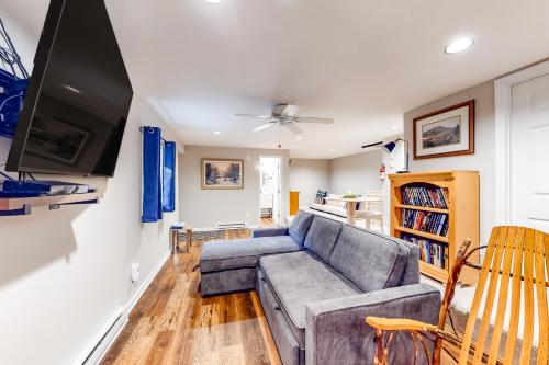 a living room with a couch and a tv at Sandy Beech in Beech Mountain