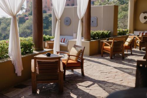 a row of chairs and tables on a patio at Cala de Mar Resort & Spa Ixtapa in Ixtapa