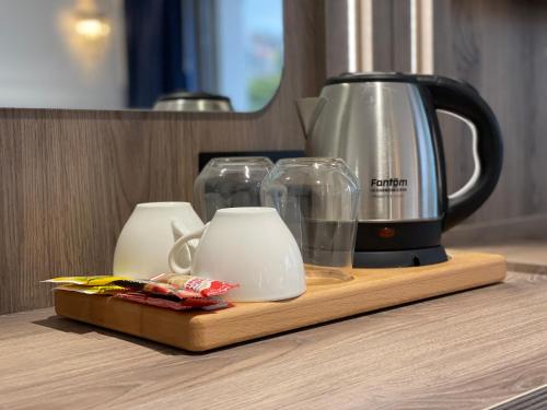 a coffee maker and cups on a cutting board at Mona Bosphorus in Istanbul