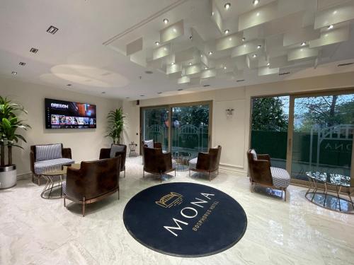 a lobby with a waiting room with chairs and a tv at Mona Bosphorus in Istanbul