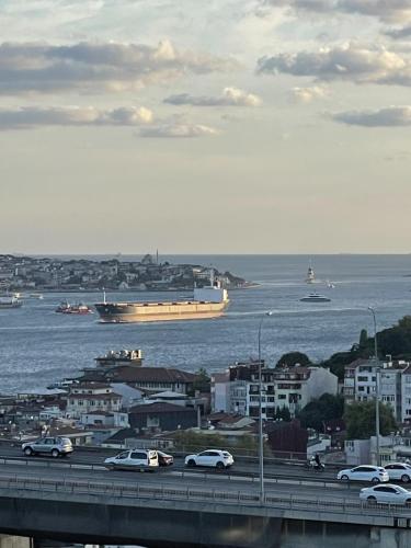 a highway with cars and a cruise ship in the water at Mona Bosphorus in Istanbul