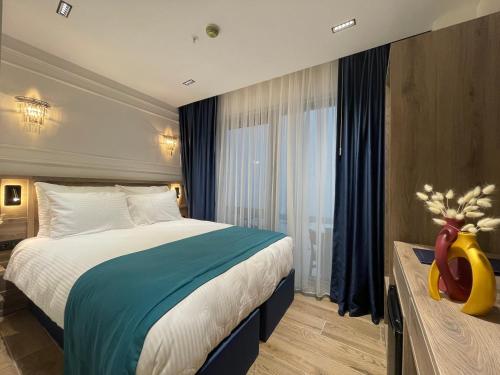 a hotel room with a large bed and a window at Mona Bosphorus in Istanbul