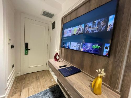 a living room with a large flat screen tv on a wall at Mona Bosphorus in Istanbul