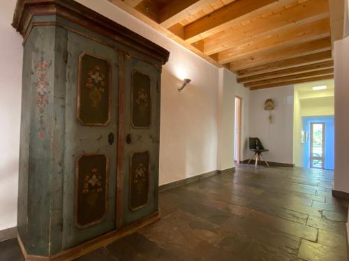 an old wooden cabinet in a room with a wooden ceiling at Chalet Ida in Haiming