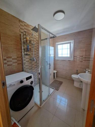 a bathroom with a shower and a toilet and a sink at Maravillosas vistas in Mantinos