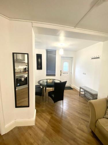 a living room with a table and a couch at Furnished 1 bedroom apartment in Bristol
