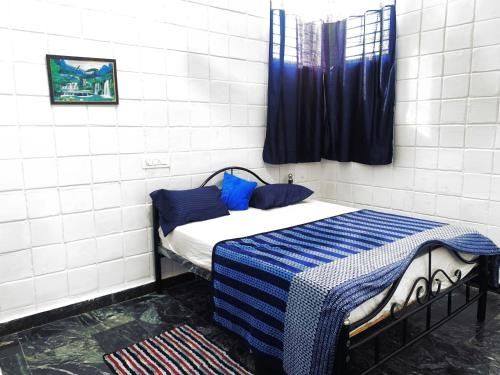 Postelja oz. postelje v sobi nastanitve Mannat Inn TS Mysore - Premium Homestay