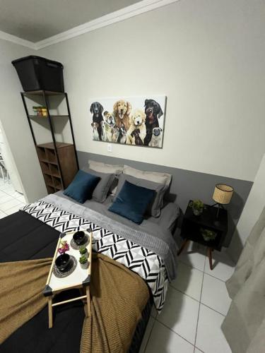 a bedroom with a bed with dogs on the wall at Travellar Spot 313B in Ribeirão Preto