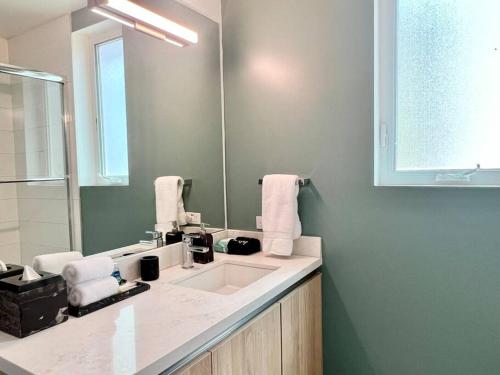 a bathroom with a sink and a mirror at Designer Hollywood Penthouse with Private Balcony on Sunset in Los Angeles