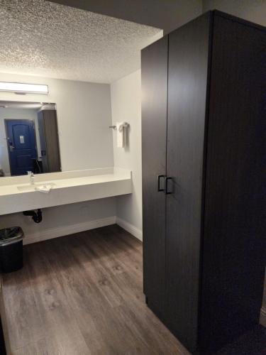 a bathroom with a sink and a mirror at Studio 6 Sacramento, CA Natomas in Sacramento