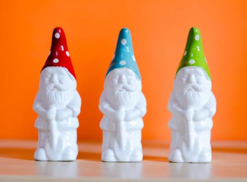 three gnome toy caps sitting on a table at Albergo Villa Gaia in Chianciano Terme