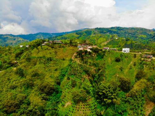 an aerial view of a hill with houses on it at Mountain View Hostel in Manizales