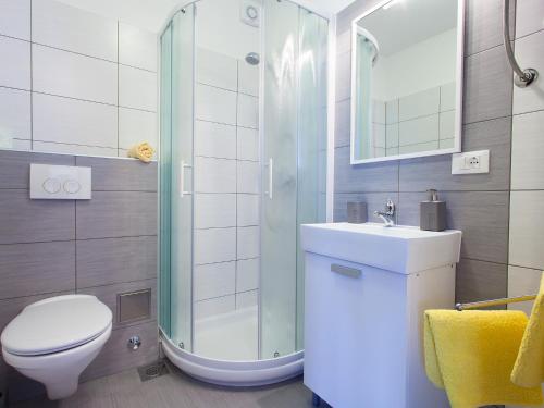 a bathroom with a shower and a toilet and a sink at Apartment Červar in Poreč