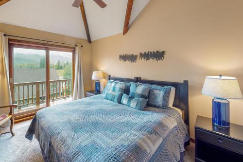 a bedroom with a bed and a large window at Purgatory Perch in Durango Mountain Resort