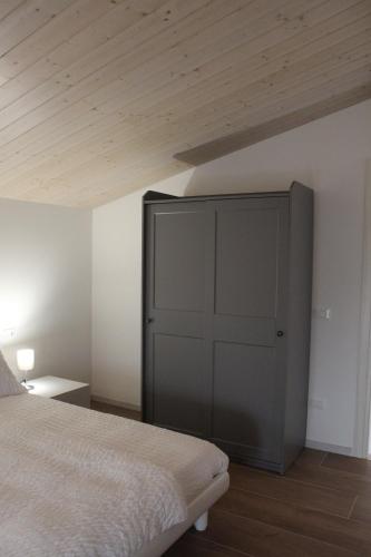 a bedroom with a bed and a wooden ceiling at Guest House Italo & Anna in Pasian di Prato
