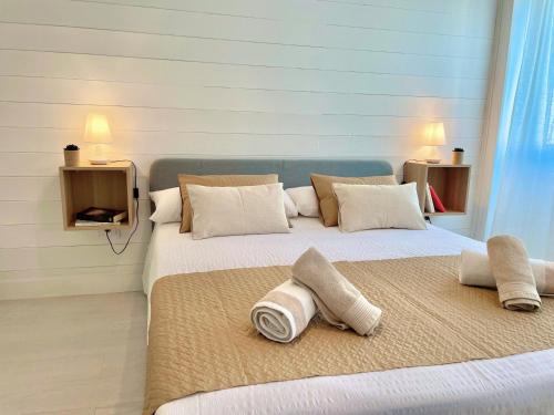 a bedroom with a large bed with towels on it at Las Brisas 2 by SunHousesCanarias in Las Palmas de Gran Canaria