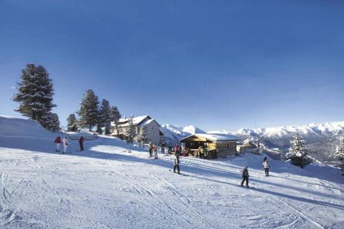 a group of people skiing down a snow covered slope at Chalet Ida in Haiming