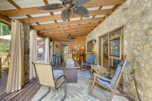 a porch with two chairs and a ceiling fan at Pet-Friendly Hickory Vacation Rental with Fire Pit! in Hickory