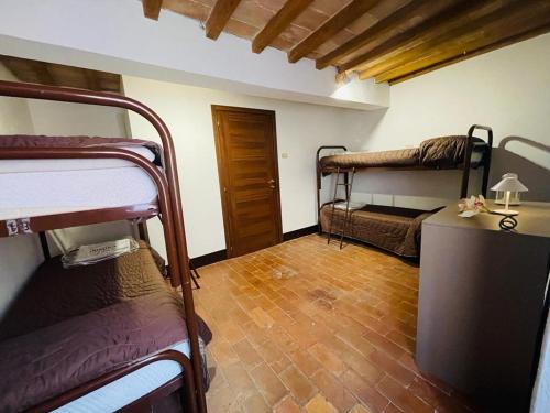 a room with two bunk beds and a wooden floor at Casa del Viandante Borgo dei Sassi di Roccamalatina in Guiglia