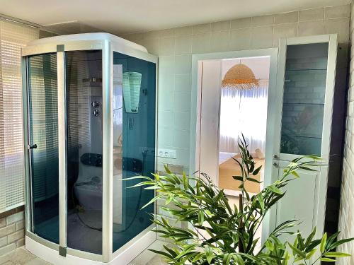 a bathroom with a glass shower with a toilet at Las Brisas 2 by SunHousesCanarias in Las Palmas de Gran Canaria