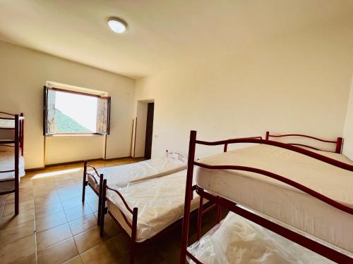 two bunk beds in a room with a window at Rifugio Acquaviva in Formia