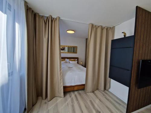 a bedroom with a bed and a window with curtains at 7thHeaven centre suite FREE PARKING in the building in Bratislava