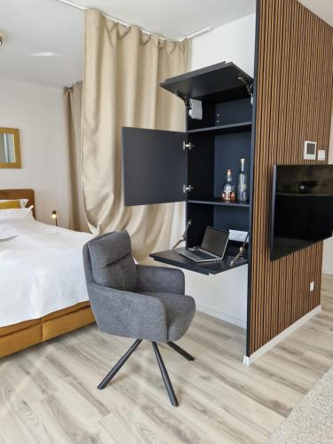 a bedroom with a bed and a desk and a chair at 7thHeaven centre suite FREE PARKING in the building in Bratislava