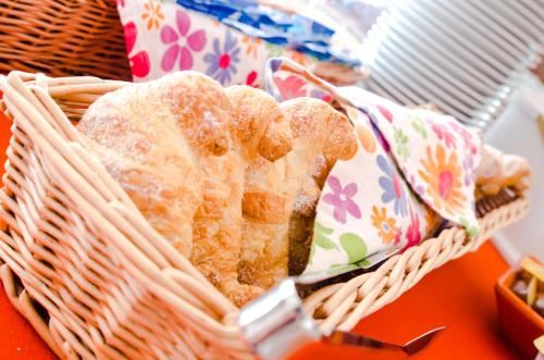 a basket filled with pastries on top of a table at Albergo Villa Gaia in Chianciano Terme