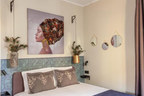 a bedroom with a bed with a picture on the wall at Charisma in Haskovo