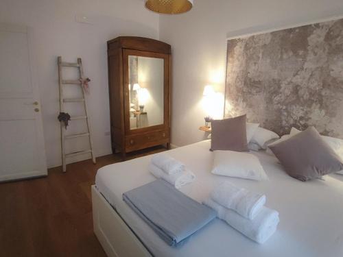 ein Schlafzimmer mit einem weißen Bett und Handtüchern darauf in der Unterkunft Annamaria Rooms in Neapel