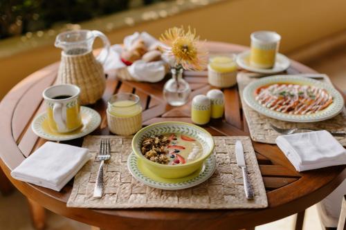 a wooden table with plates of food on it at Cala de Mar Resort & Spa Ixtapa in Ixtapa