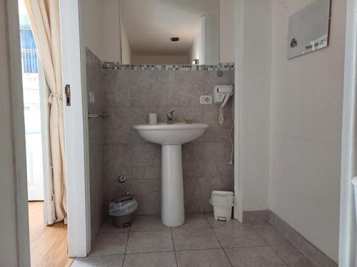 a bathroom with a sink and a toilet at Giardino Siciliano B&B in Catania