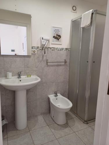 a bathroom with a sink and a toilet at Giardino Siciliano B&B in Catania