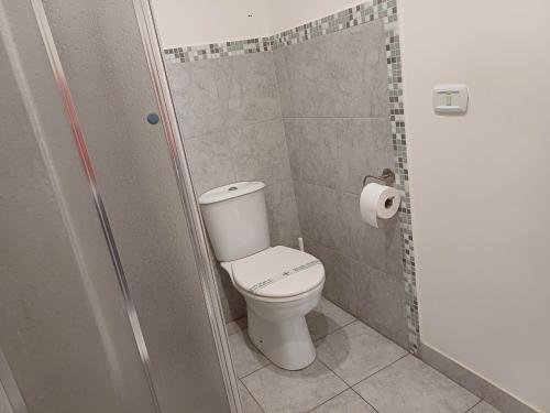 a bathroom with a toilet and a roll of toilet paper at Giardino Siciliano B&B in Catania