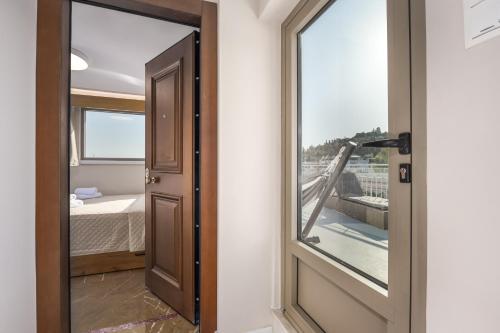 a door leading to a bedroom with a balcony at Acropolis and Odeon Panorama in Athens
