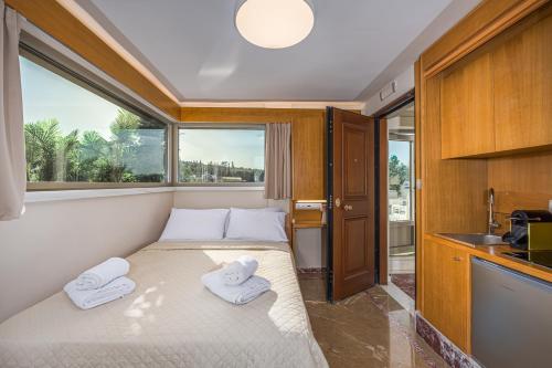 a small bedroom with a bed with towels on it at Acropolis and Odeon Panorama in Athens