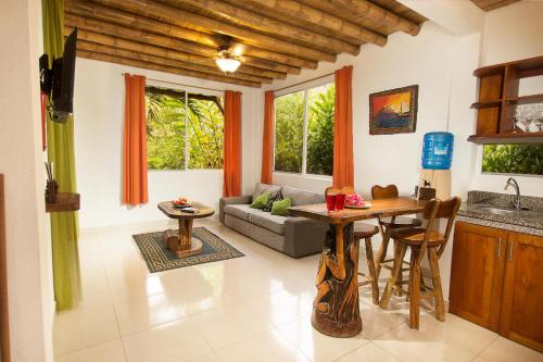 a living room with a table and a couch at ITCHIMBIA GARDEN AYAMPE Montaña y Mar in Ayampe