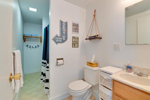 a bathroom with a toilet and a sink at Lake George Waterfront Cabin with On-Site Marina! in Bolton Landing