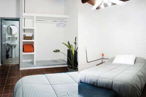 two images of a bedroom with a bed and a mirror at MARGAHOME in Maipú