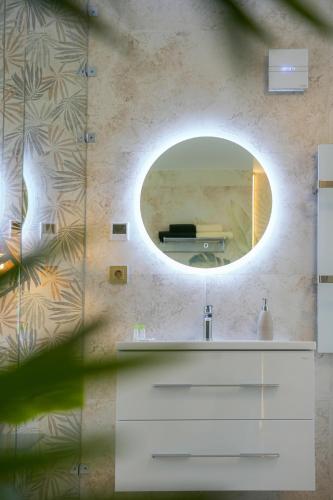 a bathroom with a sink and a mirror at Welcome House Eger in Eger