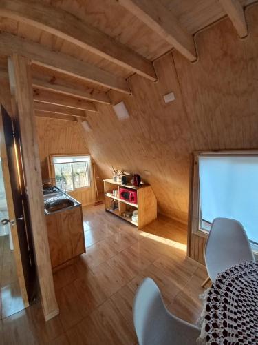 a room with a table and a screen in a house at Cabañas Verde Pirámide in Ñilque