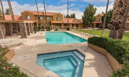 a swimming pool in the middle of a yard at Mountain Foot Condo - Near Tempe and PHX Airport in Phoenix