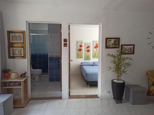 um banheiro com chuveiro e uma cama em um quarto em Casa Laureles - San Joaquín em Medellín