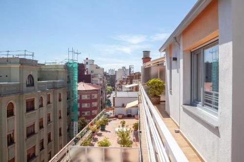 an apartment balcony with a view of a city at BURGO NUEVO Ático de lujo en pleno centro con terraza y vistas - leonapartamentos in León
