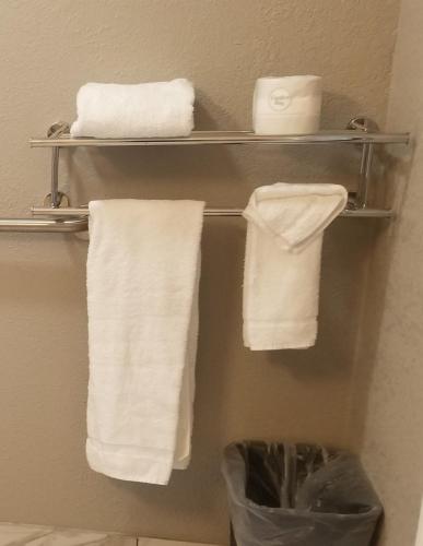 a bathroom with white towels on a towel rack at Studio 6 Sacramento, CA Natomas in Sacramento
