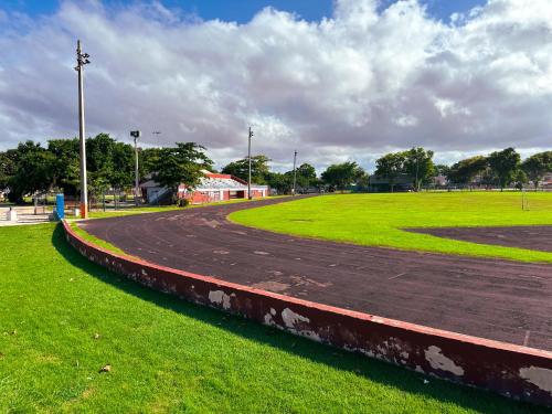 a dirt road in a park with a green field at OMERO Ocean Park in San Juan