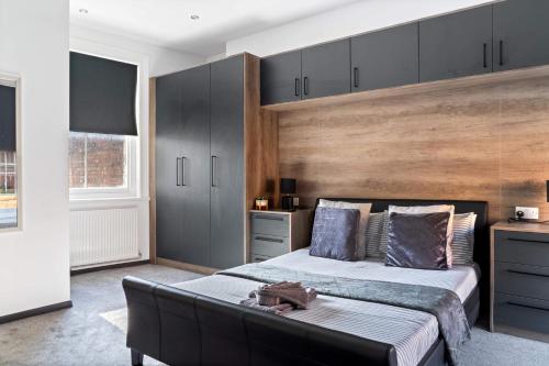 a bedroom with a bed and a couch in it at Cowgate Luxury Apartments in Peterborough