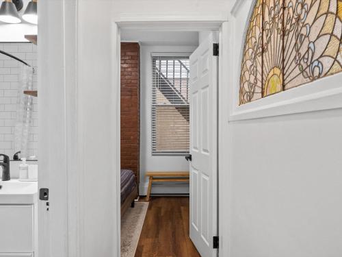 a hallway with a door with a stained glass window at Shadyside, Pittsburgh, Modern and Accessible 2 Bedroom Unit2 with Free Parking in Pittsburgh
